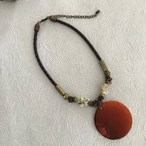 Chico burnt orange medallion with braided leather.